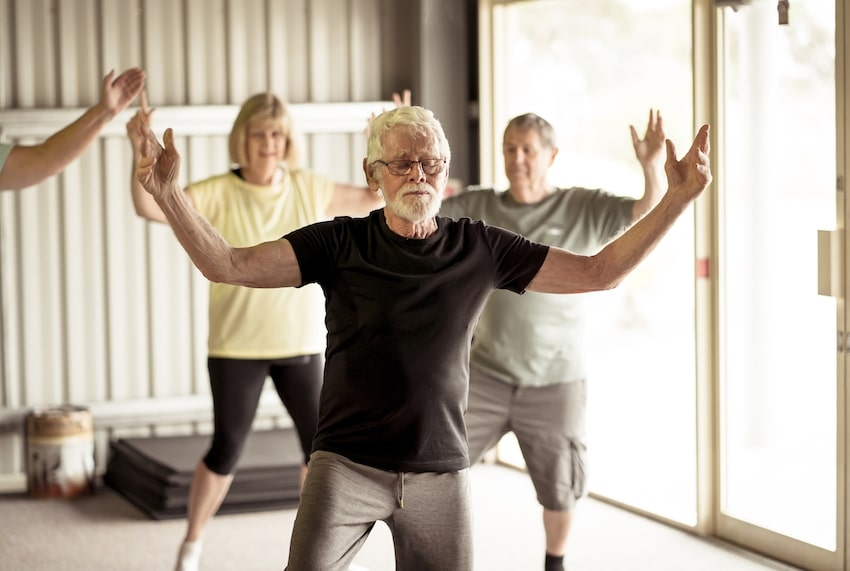 Older man taking tai chi class for mental health